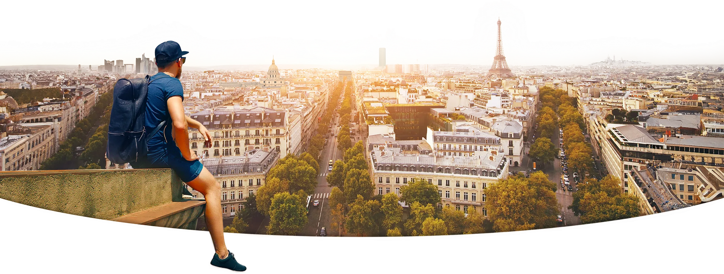 A backpacker looking out over Paris at golden hour.